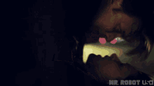 a man and a woman are kissing in a dark room with the words mr robot usa in the corner .