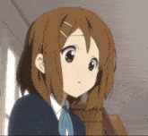 a close up of a girl 's face with brown hair