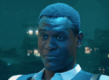 a close up of a man 's face with blue paint on it