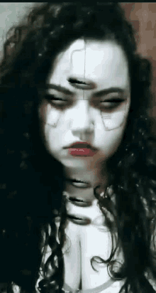a close up of a woman 's face with a scary face painted on her face .