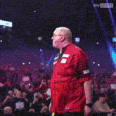 a man in a red and black striped shirt with the letter e on it