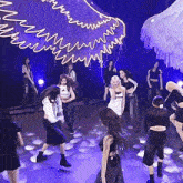 a group of young women are dancing on a stage