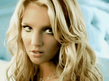 a close up of a woman 's face with a blue background