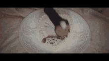 a person cutting a heart shaped cake on a white plate