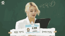 a girl in a white shirt and tie is clapping her hands while sitting in a classroom with other girls .
