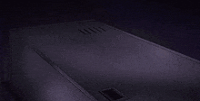 a man is laying in a coffin with his arm up in the air .