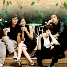 a group of people are sitting on the steps of a building .