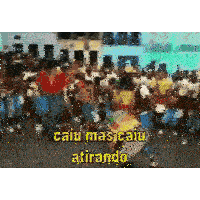 a group of people are dancing in front of a crowd with the words caiu mas caiu atirando written on the bottom .