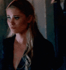a close up of a woman 's face with a ponytail .