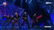 a group of men are dancing on a stage with the hashtag mama
