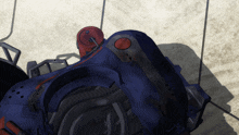 a close up of a blue object with a red button on the side