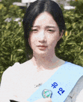 a girl wearing a sash that says ' seoul ' on it