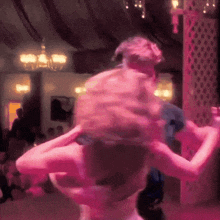 a blurry picture of a man and woman dancing in a room