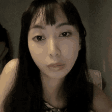 a close up of a woman 's face with long hair