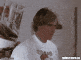 a man wearing a moose t-shirt is making a funny face .