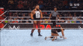 a wrestler wearing a one big sob tank top is standing in the ring