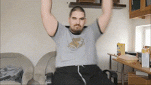 a man wearing a shirt that says ' harry potter ' on it is lifting his arms in the air