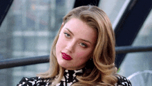 a close up of a woman 's face with red lipstick on her lips