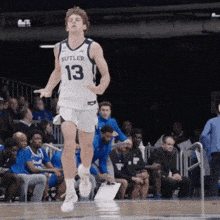 a man wearing a butler jersey is running on a basketball court