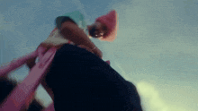 a blurry picture of a person standing on a pink ladder