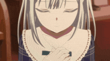 a girl with white hair is praying with her eyes closed and her hands folded