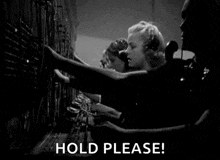 a black and white photo of a group of people working on a telephone switchboard .