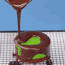 chocolate is being poured on a cake that has a hole in it