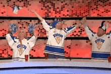 a group of people wearing shirts that say suomi are cheering