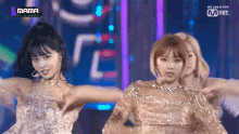 a group of women are dancing on a stage with a sign that says mama on it .