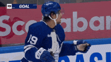 a hockey player in a blue jersey with the number 19 on it