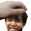 a close up of a person 's face with a hand holding it .