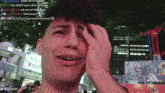 a man is crying in front of a sign that says ' link with jason ' on it