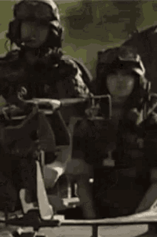 a person wearing a helmet and goggles is giving a peace sign while sitting in a chair .