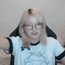 a woman wearing glasses and a t-shirt that says ' s ' on it