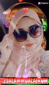 a picture of a woman wearing sunglasses and a hijab with the words " issalammualaikum "