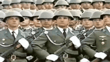 a group of soldiers marching in a line with their guns