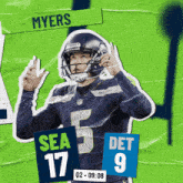 a football player for the seahawks holds up his hands in the air
