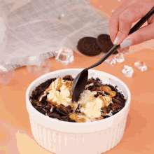 a person is scooping ice cream into a bowl