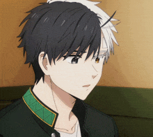 a close up of a boy with black and white hair