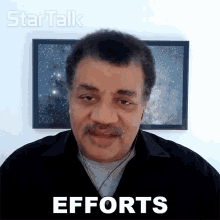 a man in front of a framed picture with the word efforts on it