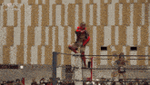 a person in a red and black costume with the word stardom on the bottom right