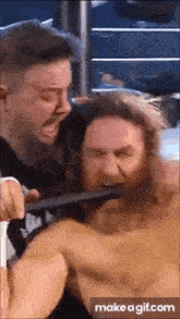 a man with a sword in his mouth is being attacked by another man with a sword in his mouth .