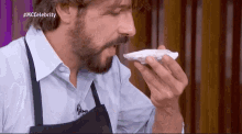 a man with a beard is eating a piece of food with the hashtag #mccelebrity on the bottom