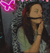 a woman wearing a headset with the letter d on her sleeve