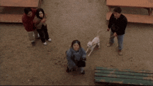 a group of people are standing around a dog with the caption get the hell away from there