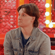 a man wearing a calvin klein denim jacket