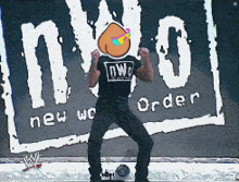 a man is standing in front of a new world order sign