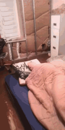 a person is laying on a bed with a blanket on top of them