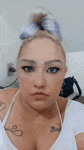 a woman with a tattoo on her chest that says ' quil ' on it