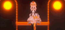 a girl in a white dress is standing on a stage with a yellow light behind her .
